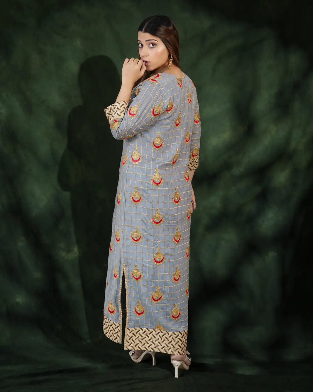 Angled view of grey embroidered festive long dress design