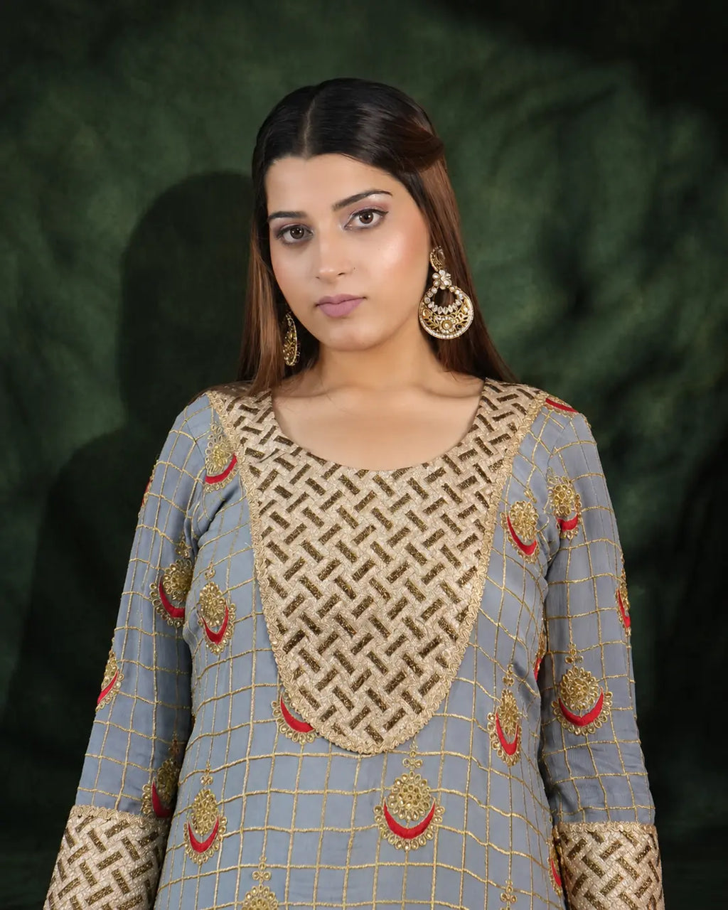 Close-up of grey long dress neckline and gold embroidery