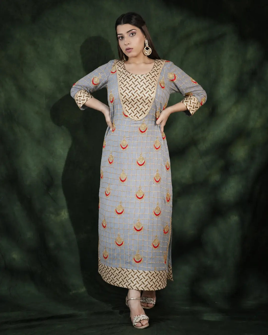 Model wearing grey festive long dress with gold embroidery