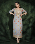Model wearing grey festive long dress with gold embroidery
