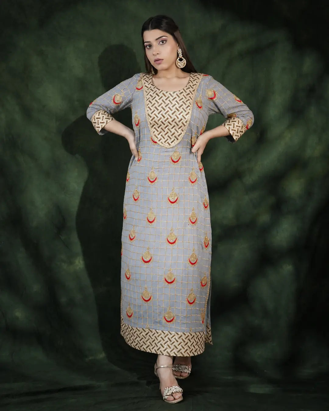 Model wearing grey festive long dress with gold embroidery